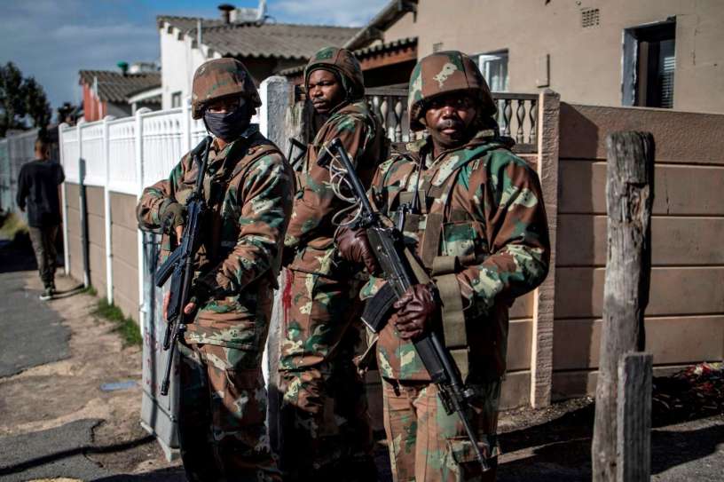SANDF soldiers secure the perimeter of a police operation during a joint patrol with the South African police in the Cape Flats area in Cape Town, on August 8, 2019.