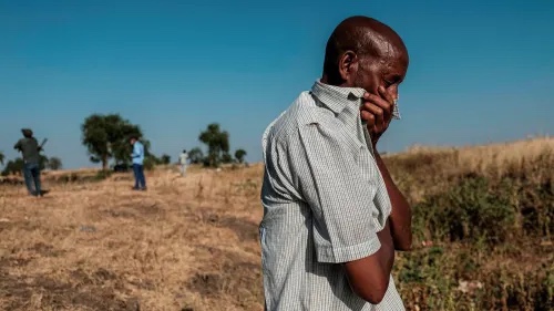 A man looks at bodies in a ditch in Mai-Kadra, Ethiopia. There have been all-too-credible accounts of civilian massacres on all sides 