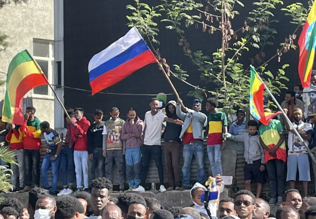 The Russian flag is carried in a crowd in the national plaza in Ouagadougou, the capitol of Burkina Faso, the day after a military coup, Jan. 25, 2022. (Malin Fezehai/The New York Times)
