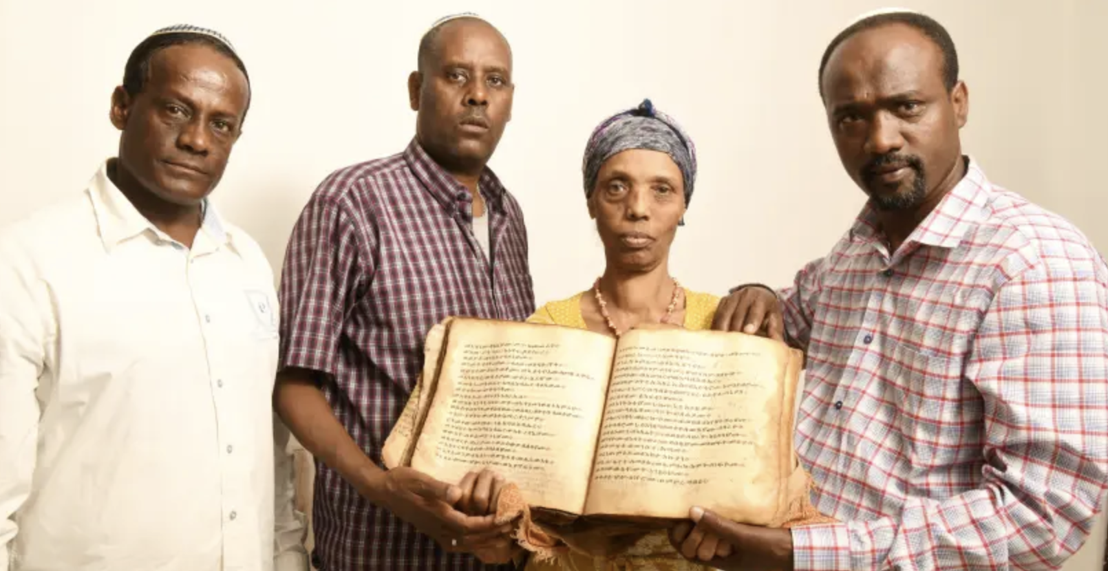 Ayanawo Ferada Senebato, right, and his family shown in Ashkelon, Israel, holding an ancient Orit book that they retrieved near Gondar, Ethiopia, in February 2022. Ayanawo Ferada Senebato, right, and his family shown in Ashkelon, Israel, holding an ancient Orit book that they retrieved near Gondar, Ethiopia, in February 2022. (photo credit: YOSSI ZELIGER)