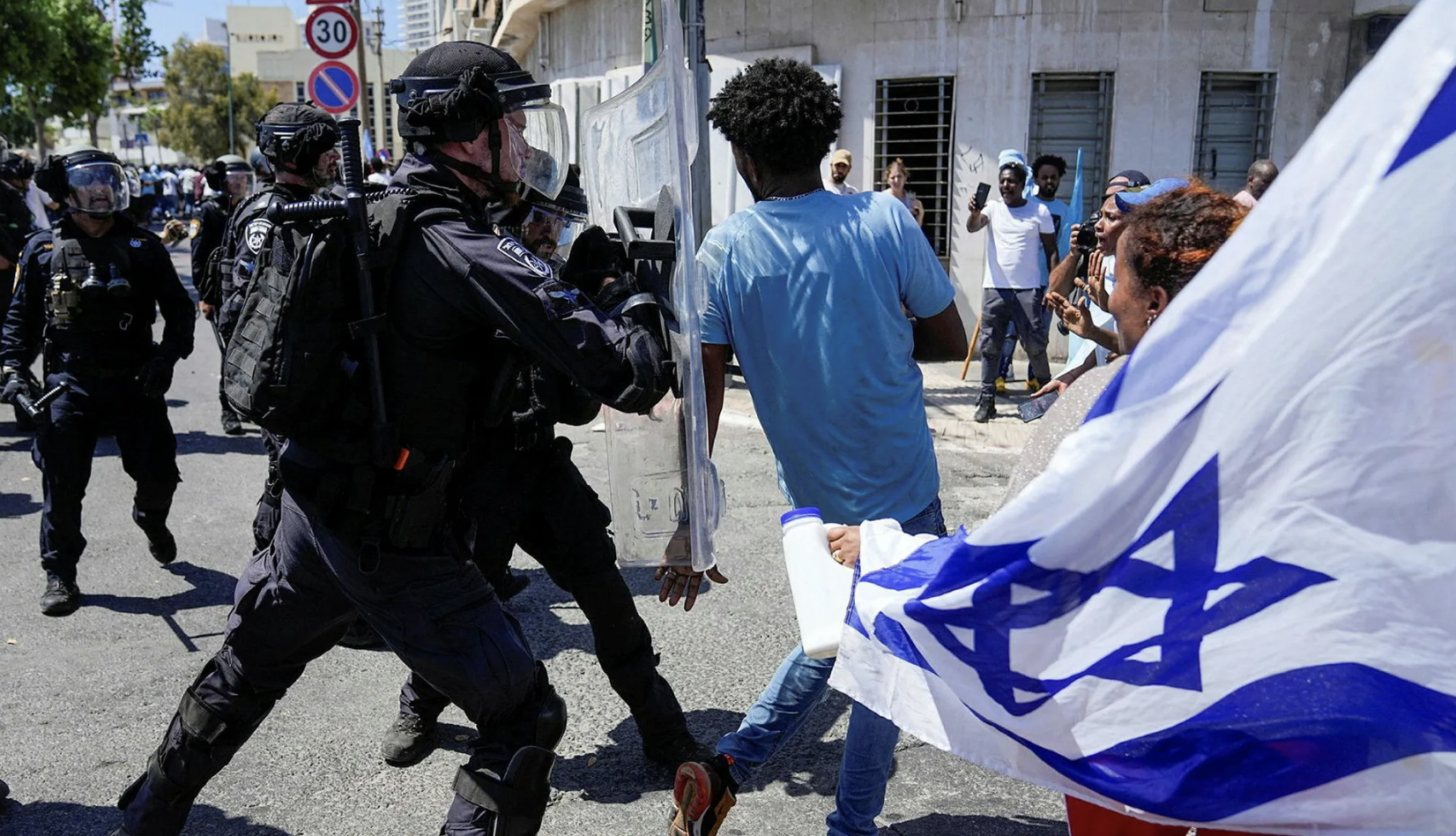 Eritrean protesters clash with Israeli riot police in Tel Aviv, Israel, on Saturday.