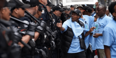 Toronto police confront protesters outside a Sheraton Hotel on Aug. 6, 2023, after the city revoked the Eritrean festival's permit for the long weekend.
