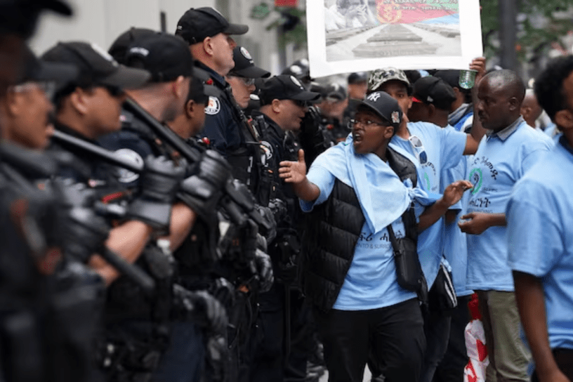 Toronto police confront protesters outside a Sheraton Hotel on Aug. 6, 2023, after the city revoked the Eritrean festival's permit for the long weekend.
