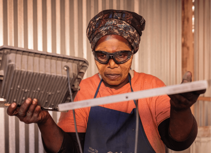 The owner of a Langa food stall holding her panel